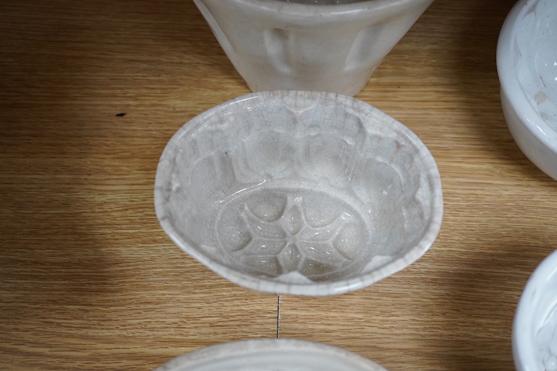 A collection of fifteen mostly 20th century ceramic jelly moulds, largest 16cm high